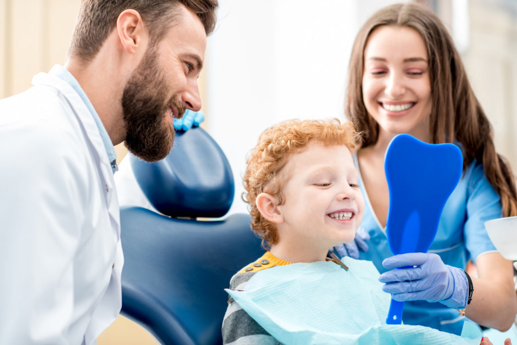 Boy with dentist at the dental office