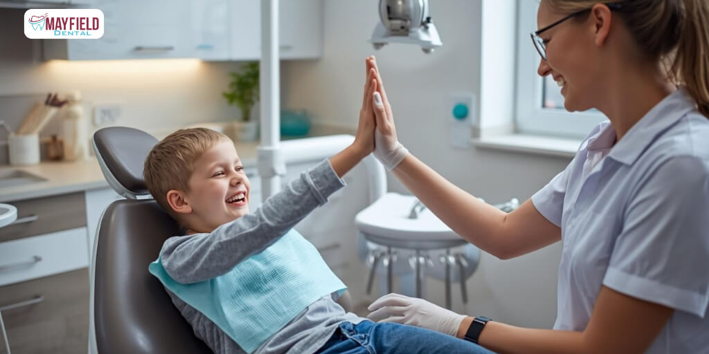 Child visiting Brampton children’s dentist at Mayfield Dental Clinic smiling with dentist.
